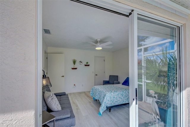 bedroom with light hardwood / wood-style floors and ceiling fan