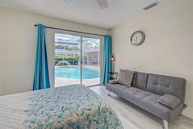 bedroom featuring access to outside, light wood-type flooring, and ceiling fan