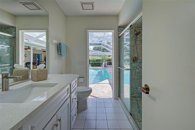 bathroom featuring toilet, tile patterned flooring, vanity, an enclosed shower, and ceiling fan