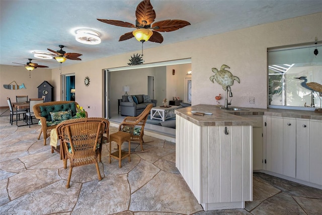 dining room with ceiling fan and sink