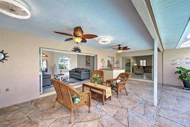 interior space with ceiling fan