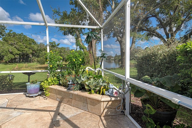 unfurnished sunroom featuring a water view