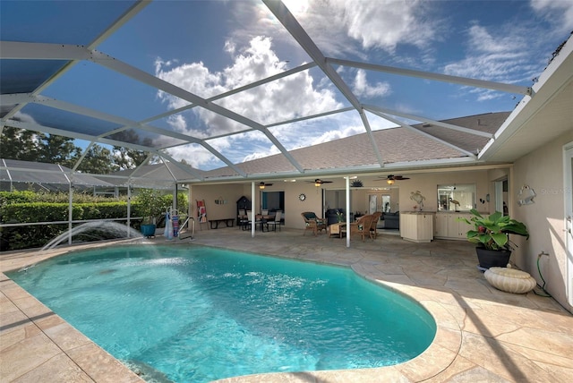 view of pool featuring a patio, ceiling fan, and a lanai