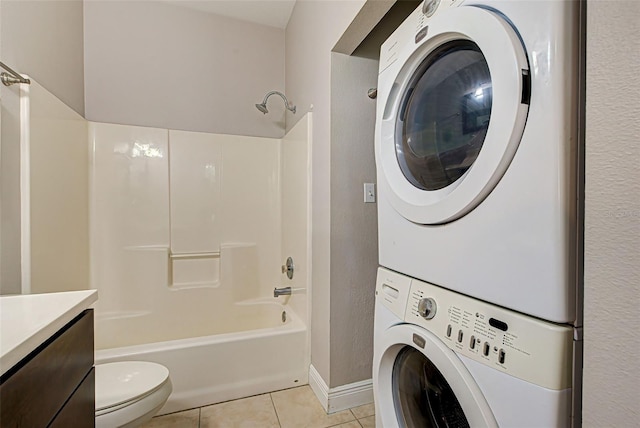 full bathroom with vanity, tile patterned flooring, stacked washer / dryer, toilet, and shower / bathing tub combination