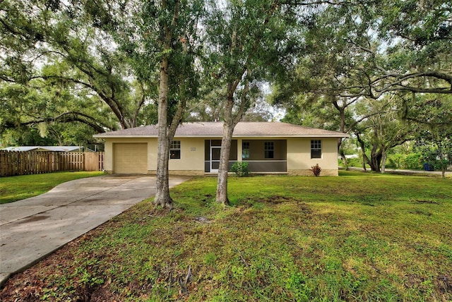 ranch-style home with a garage and a front lawn