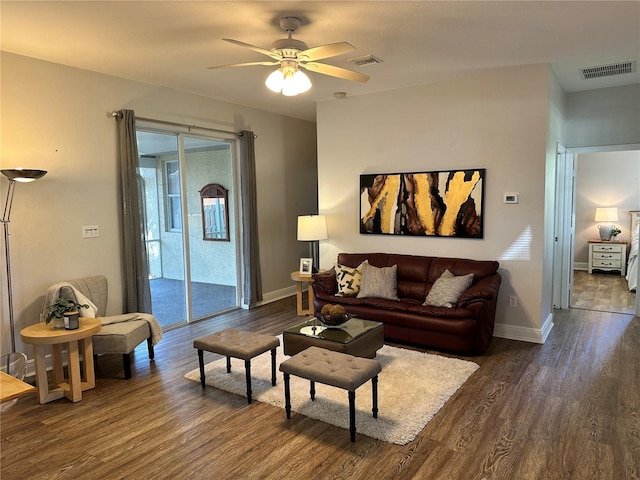 living room with a wealth of natural light, ceiling fan, and dark hardwood / wood-style floors