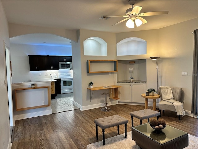 living room featuring dark hardwood / wood-style floors and ceiling fan