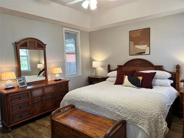 bedroom with multiple windows, dark hardwood / wood-style floors, and ceiling fan