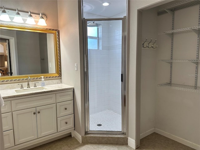 bathroom featuring tile patterned flooring, vanity, and a shower with door