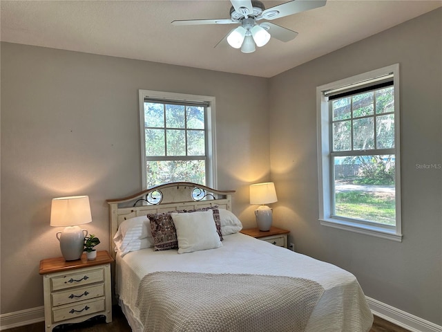 bedroom with dark hardwood / wood-style flooring and ceiling fan