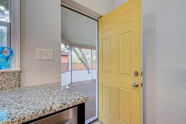 entryway with carpet floors and beverage cooler