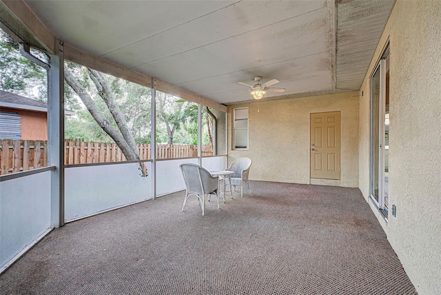 unfurnished sunroom featuring ceiling fan