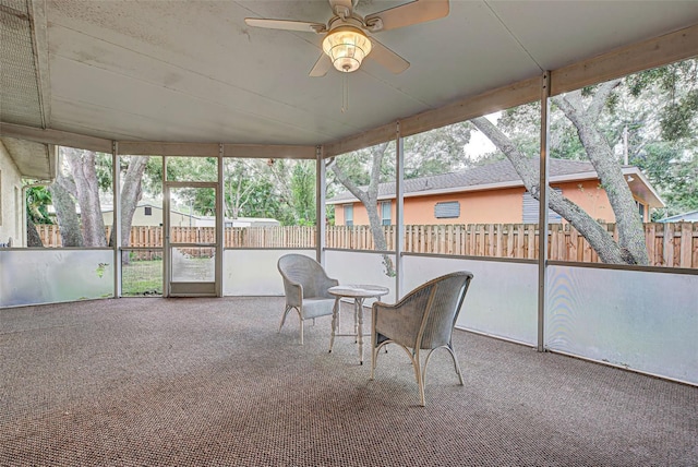 unfurnished sunroom with ceiling fan