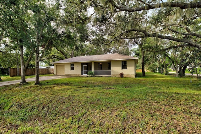 ranch-style home with a garage and a front lawn