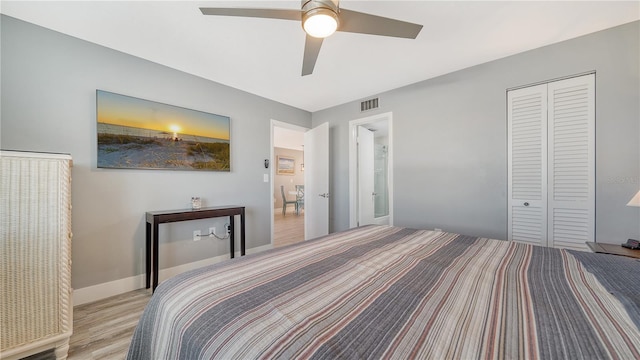 bedroom featuring ceiling fan, a closet, and light hardwood / wood-style flooring