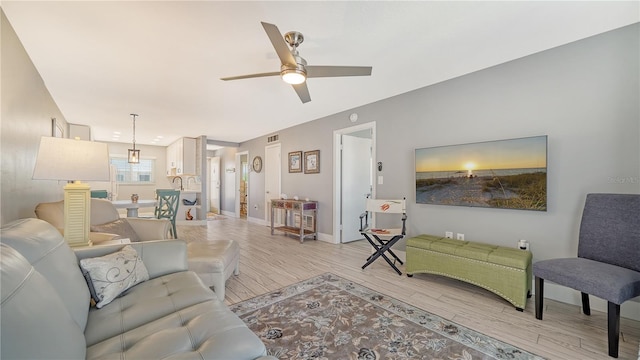 living room featuring ceiling fan and light hardwood / wood-style flooring