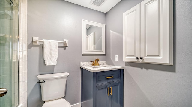 bathroom featuring toilet, walk in shower, and vanity