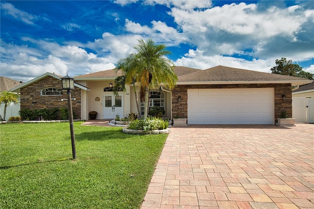 ranch-style home featuring a front lawn and a garage