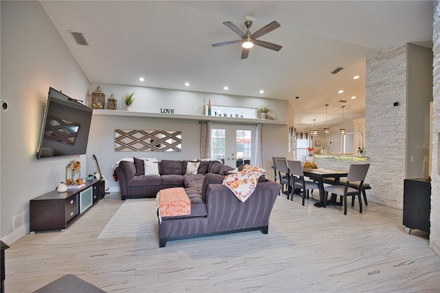 living room with ceiling fan and light hardwood / wood-style flooring