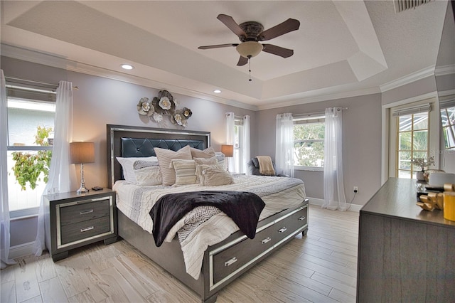 bedroom featuring ornamental molding, light hardwood / wood-style floors, multiple windows, and ceiling fan