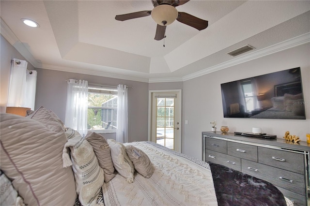 bedroom with access to outside, a tray ceiling, crown molding, and ceiling fan