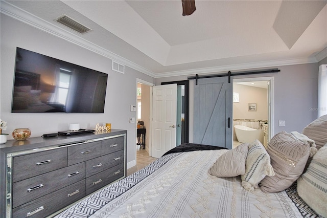 bedroom with ceiling fan, ornamental molding, ensuite bath, and a barn door