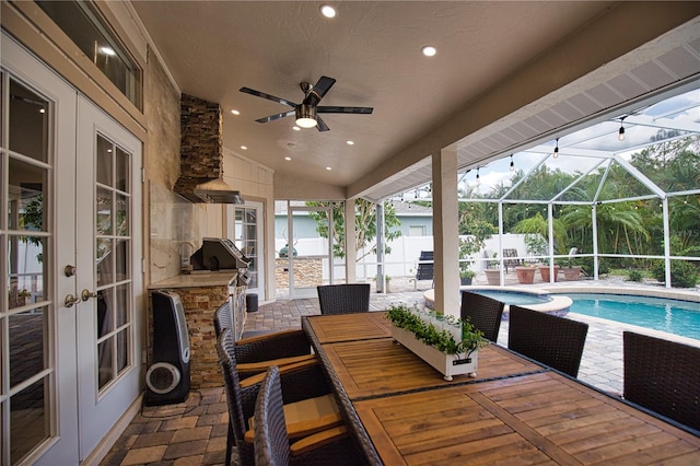 view of patio featuring ceiling fan, french doors, and a lanai