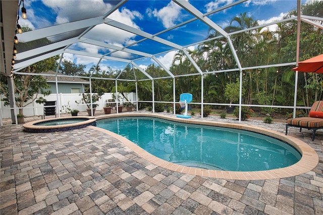 view of swimming pool with an in ground hot tub, a lanai, and a patio area