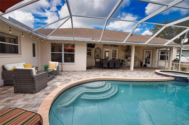 view of swimming pool with a lanai, an in ground hot tub, and a patio area