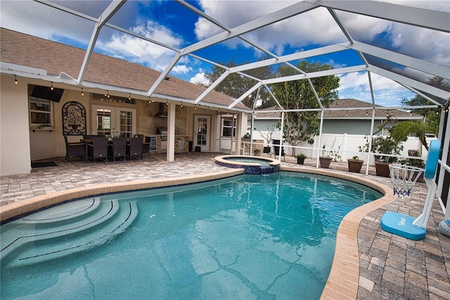 view of swimming pool with french doors, a patio, glass enclosure, and an in ground hot tub