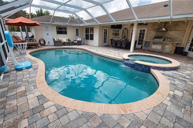 view of swimming pool with an outdoor kitchen, a patio area, area for grilling, an in ground hot tub, and glass enclosure