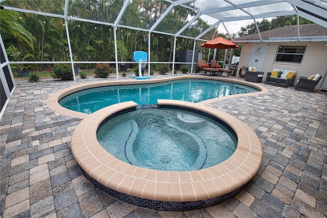 view of swimming pool featuring a lanai, an in ground hot tub, and a patio area