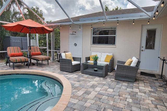 view of swimming pool with an outdoor hangout area, a patio, and a lanai