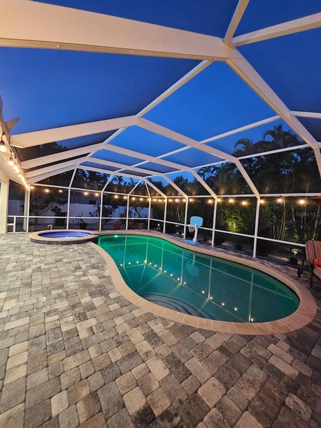 view of pool featuring an in ground hot tub, a lanai, and a patio area