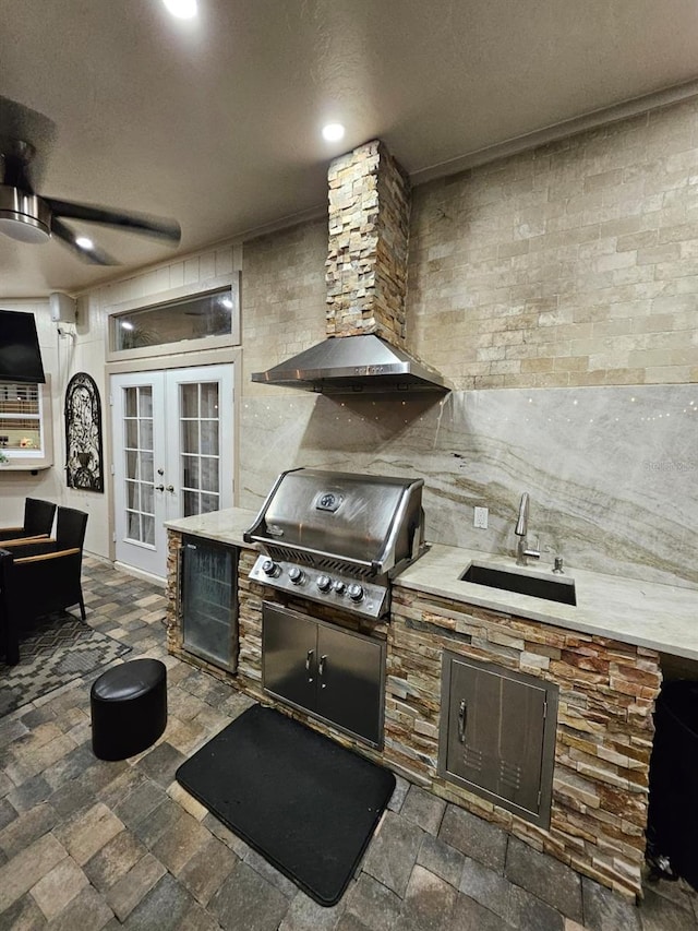 view of patio featuring exterior kitchen, area for grilling, french doors, and sink