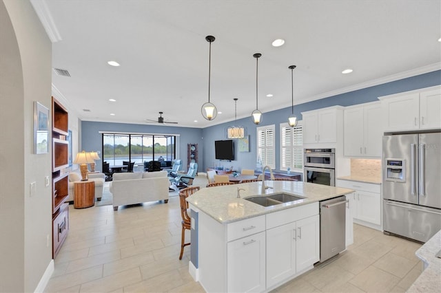 kitchen with stainless steel appliances, white cabinetry, ceiling fan, and sink