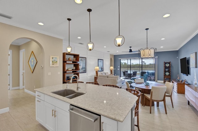 kitchen featuring dishwasher, decorative light fixtures, sink, and white cabinetry