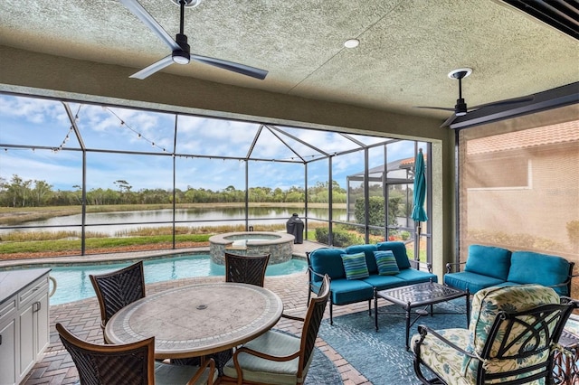 view of patio / terrace with a pool with hot tub, outdoor lounge area, a water view, glass enclosure, and ceiling fan