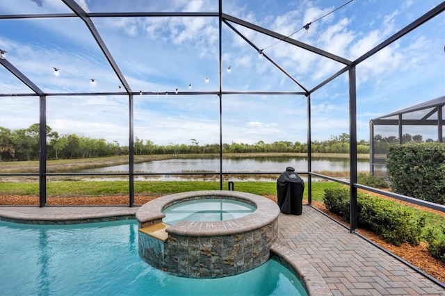 view of pool with a lanai, a water view, and an in ground hot tub