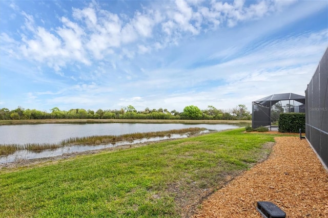 exterior space with a water view and glass enclosure