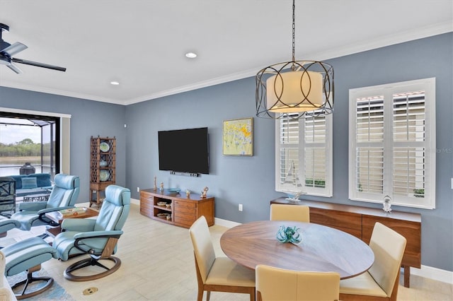 dining space featuring ceiling fan and crown molding