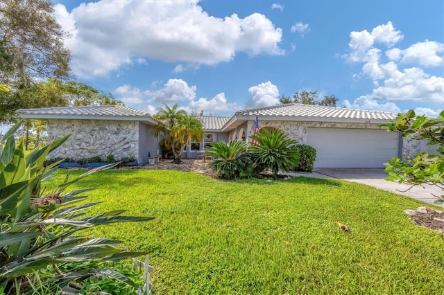 view of front of property featuring a garage and a front yard