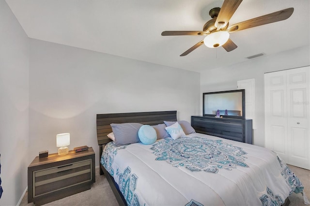 carpeted bedroom with a closet and ceiling fan