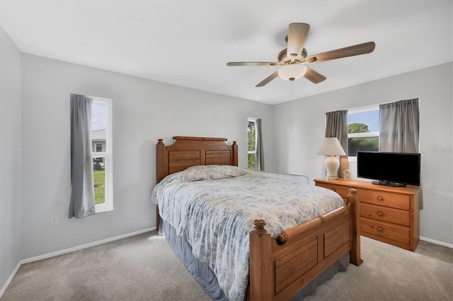 bedroom with light carpet and ceiling fan