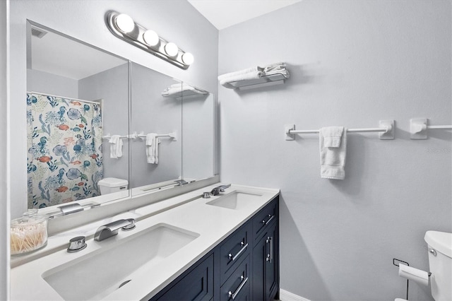 bathroom featuring walk in shower, vanity, and toilet