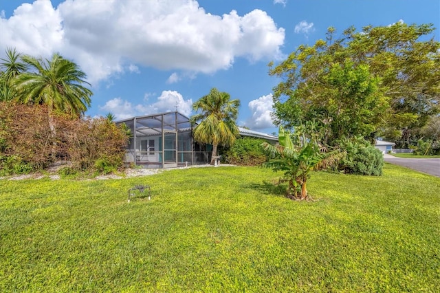 view of yard with glass enclosure