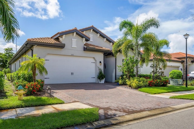 mediterranean / spanish-style house with a garage