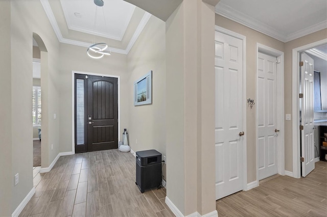 entryway featuring light hardwood / wood-style flooring and crown molding