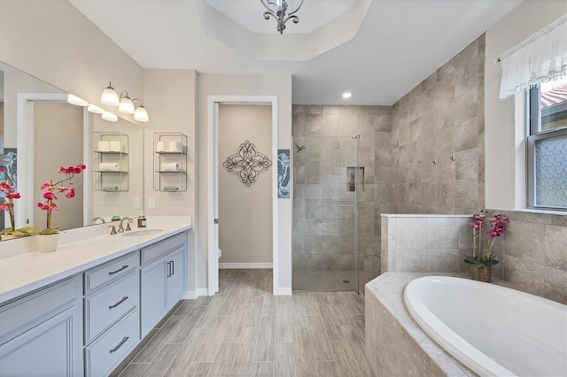 full bathroom with shower with separate bathtub, vanity, and toilet