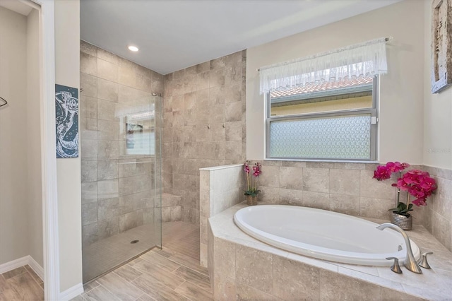 bathroom featuring independent shower and bath